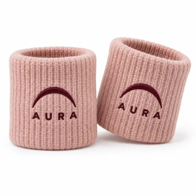 Blush pink rib-knit wristbands with a burgundy embroidered arc logo and lettering